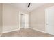 Simple carpeted bedroom with a ceiling fan, closet, and neutral color scheme at 1704 E Melrose St, Mesa, AZ 85203