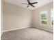 Bedroom with neutral walls, carpet flooring, ceiling fan, and sunny windows at 1704 E Melrose St, Mesa, AZ 85203