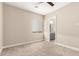 Bright bedroom featuring a neutral color palette, window with shade, and attached bathroom at 1704 E Melrose St, Mesa, AZ 85203