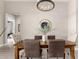 Staged dining room features a wooden table, upholstered chairs, and elegant light fixture at 1704 E Melrose St, Mesa, AZ 85203