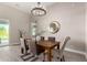 Dining room features a wooden table and upholstered chairs, and access to the outdoors at 1704 E Melrose St, Mesa, AZ 85203