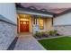 Inviting front porch with manicured shrubs, a red door, and a paver walkway at 1704 E Melrose St, Mesa, AZ 85203