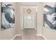Bright entryway showcasing modern lighting, neutral paint, and a white front door at 1704 E Melrose St, Mesa, AZ 85203