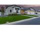 Attractive home featuring well-kept lawn, blooming bushes, and a brick and siding facade at 1704 E Melrose St, Mesa, AZ 85203
