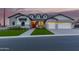 Stunning single-Gathering home with charming curb appeal, green lawn, and a welcoming red door at 1704 E Melrose St, Mesa, AZ 85203