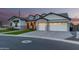 Beautiful single-story home with manicured landscaping, gray brick accents, and a spacious three-car garage at 1704 E Melrose St, Mesa, AZ 85203