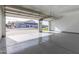 Spacious and clean three-car garage with epoxy floor and glass panel doors, ready for vehicles and projects at 1704 E Melrose St, Mesa, AZ 85203