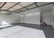 A large, clean, and well-lit garage space with an epoxy floor is ready for a car collection or home gym at 1704 E Melrose St, Mesa, AZ 85203