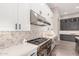 Well-equipped kitchen features stainless steel appliances, white cabinets, and a decorative backsplash at 1704 E Melrose St, Mesa, AZ 85203