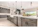 Kitchen island with stainless steel appliances and a white farm sink, overlooking the living room at 1704 E Melrose St, Mesa, AZ 85203