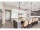 Large kitchen island features barstool seating, pendant lighting, and white countertops at 1704 E Melrose St, Mesa, AZ 85203