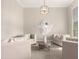 Inviting living room area features neutral decor, modern chandelier, and soft, natural light at 1704 E Melrose St, Mesa, AZ 85203