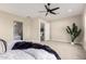 Comfortable main bedroom with modern ceiling fan, access to ensuite bath and walk-in closet at 1704 E Melrose St, Mesa, AZ 85203