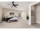 Spacious main bedroom with stylish decor, neutral tones, and carpet, flowing into the ensuite bathroom at 1704 E Melrose St, Mesa, AZ 85203