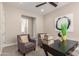 Cozy home office featuring neutral colors, a ceiling fan, and natural light at 1704 E Melrose St, Mesa, AZ 85203