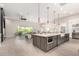 The living room opens up to the kitchen with a large island and stainless steel appliances at 1704 E Melrose St, Mesa, AZ 85203