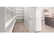 Bright pantry featuring white shelving, stylish wood flooring, and easy access to the modern kitchen at 1704 E Melrose St, Mesa, AZ 85203
