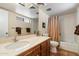Traditional bathroom features a vanity with a solid surface top, bathtub with shower and decorative tile flooring at 1725 E Staghorn Ln, Carefree, AZ 85377
