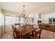 Dining room with a wooden table, chandelier, and access to the living room at 1725 E Staghorn Ln, Carefree, AZ 85377