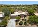 Desert home boasts golf course views, lush landscaping, and private driveway at 1725 E Staghorn Ln, Carefree, AZ 85377