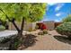 Stunning front yard with desert landscaping and a beautiful tree at 1725 E Staghorn Ln, Carefree, AZ 85377