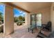 Inviting outdoor patio with comfortable seating and desert views beyond the sliding glass doors at 1725 E Staghorn Ln, Carefree, AZ 85377