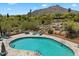 Backyard features a private swimming pool with lounge chairs, bordered by desert landscaping and mountain views at 1725 E Staghorn Ln, Carefree, AZ 85377