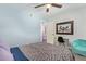 Bright bedroom with a ceiling fan, desk area, and comfortable teal beanbag chair at 1730 W Emelita Ave # 1008, Mesa, AZ 85202