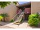 Exterior view of staircase leading to units with lush landscaping around the complex at 1730 W Emelita Ave # 1008, Mesa, AZ 85202