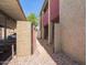 Apartment complex with brick-paved walkway to patios and covered parking at 1730 W Emelita Ave # 1008, Mesa, AZ 85202