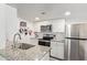 Bright kitchen with stainless steel appliances, granite countertops, and white cabinetry at 1730 W Emelita Ave # 1008, Mesa, AZ 85202