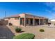 Low maintenance backyard includes a covered patio perfect for entertaining, desert landscaping, and ample privacy at 18076 W Redwood Ln, Goodyear, AZ 85338