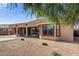 Expansive backyard featuring a covered patio, low-maintenance landscaping, and potential for outdoor activities at 18076 W Redwood Ln, Goodyear, AZ 85338