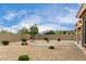 A spacious backyard featuring desert landscaping, a gravel covering, and views of mountains at 18076 W Redwood Ln, Goodyear, AZ 85338