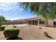 Desert landscaped backyard featuring a covered patio, mature trees, and easy upkeep for year-round enjoyment at 18076 W Redwood Ln, Goodyear, AZ 85338