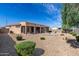 Large backyard with desert landscaping, covered patio, and pavers, perfect for entertaining or relaxing outdoors at 18076 W Redwood Ln, Goodyear, AZ 85338