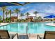 Sparkling community pool area with palm trees, shaded cabanas, and comfortable lounge chairs at 18076 W Redwood Ln, Goodyear, AZ 85338