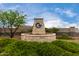 Elegant stone community sign surrounded by lush greenery and meticulous landscaping on a sunny day at 18076 W Redwood Ln, Goodyear, AZ 85338