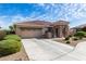 Well-maintained home with a spacious driveway and desert landscaping, creating a welcoming exterior at 18076 W Redwood Ln, Goodyear, AZ 85338
