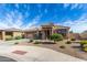 Inviting home with a tile roof, a two-car garage, and low-maintenance landscaping at 18076 W Redwood Ln, Goodyear, AZ 85338