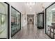 Bright community center hallway with glass-walled activity rooms, modern lighting, and sleek flooring at 18076 W Redwood Ln, Goodyear, AZ 85338