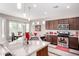 Granite countertops and stainless steel appliances complement this well-equipped kitchen with casual dining space at 18076 W Redwood Ln, Goodyear, AZ 85338