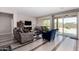 Open-concept living area with tile floors, slider door, and comfortable seating arrangement at 18076 W Redwood Ln, Goodyear, AZ 85338