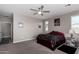 Serene main bedroom providing a relaxing retreat with ceiling fan, plush carpeting and natural light at 18076 W Redwood Ln, Goodyear, AZ 85338