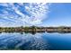 Stunning pond view featuring tranquil water reflections and beautiful homes, perfect for serene living at 18076 W Redwood Ln, Goodyear, AZ 85338