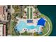 Aerial view showcasing the community pool, landscaping, and lounging areas near the tranquil lake at 18076 W Redwood Ln, Goodyear, AZ 85338