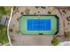 Aerial view of the tennis court, bordered by greenery, offering a scenic spot for recreation and exercise at 18076 W Redwood Ln, Goodyear, AZ 85338