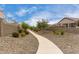 Scenic community walkway lined with desert landscaping and views of nearby homes at 18076 W Redwood Ln, Goodyear, AZ 85338
