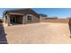Unlandscaped backyard featuring covered patio, block wall and home exterior at 18189 W Hess St, Goodyear, AZ 85338