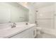 A bright bathroom features double sinks and a shower and tub combo at 18189 W Hess St, Goodyear, AZ 85338